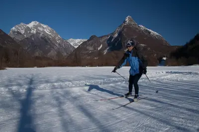 a man is cross country skiing in the snow at Apartment Montis Bovec in Bovec