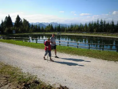 a man and a boy walking down a dirt road at Alpska perla Apartments in Cerkno