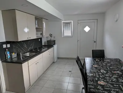 a kitchen with a sink and a table with a counter top at Apartment Mojca near Bled in Zabreznica