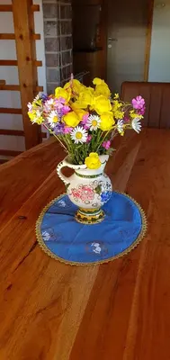 a vase filled with flowers sitting on a table at Holiday house Žvan na Pokljuki in Bohinj