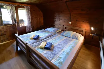 a bedroom with a bed with two pillows on it at Holiday house Žvan na Pokljuki in Bohinj