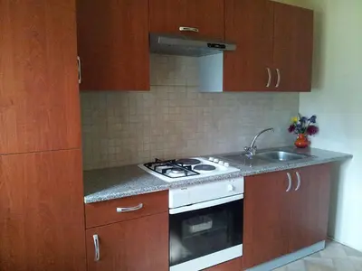 a kitchen with a stove and a sink at Apartments and rooms Oasis of peace in Bovec