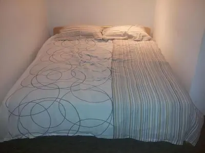 a bed in a corner of a room at Apartments and rooms Oasis of peace in Bovec