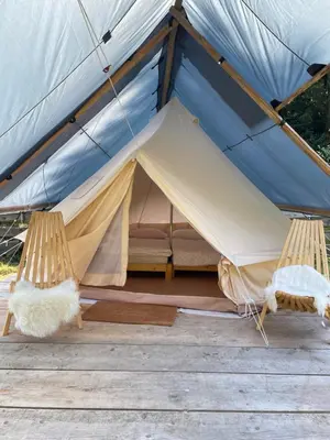 a tent with two beds inside of it at Wooden Cabin Kamna Gorica in Kamna Gorica
