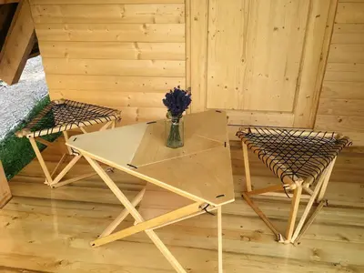 a table and two chairs in a sauna at Wooden Cabin Kamna Gorica in Kamna Gorica