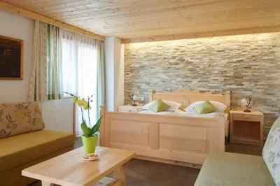a bedroom with a bed and a brick wall at Penzion Berc in Bled