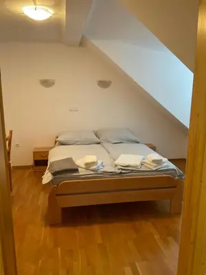 a bedroom with a bed in a attic at TURISTIČNA KMETIJA STREVC in Solčava