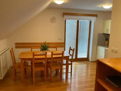 a kitchen and dining room with a table and chairs at TURISTIČNA KMETIJA STREVC in Solčava