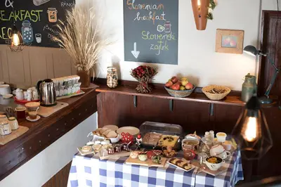 a table with a table cloth with food on it at Bed & Breakfast Dvorec in Petrovče