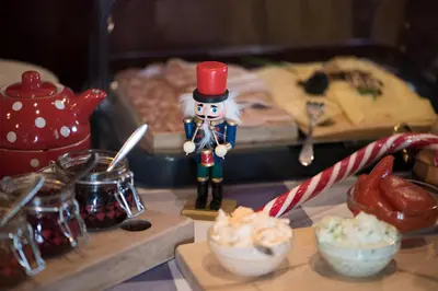 a figurine of a nutcracker on a table with food at Bed & Breakfast Dvorec in Petrovče