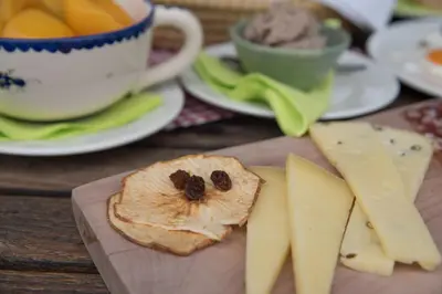 a piece of bread with a dog on it and cheese at Bed & Breakfast Dvorec in Petrovče