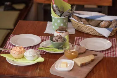 a table with plates of food on a table at Bed & Breakfast Dvorec in Petrovče