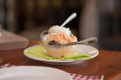 a bowl of ice cream on a plate on a table at Bed & Breakfast Dvorec in Petrovče
