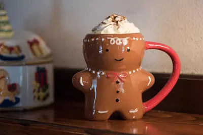 a gingerbread cup with whipped cream on top of it at Bed & Breakfast Dvorec in Petrovče