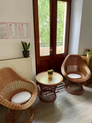 two wicker chairs and a table in a room at Apartment Tina in Bovec