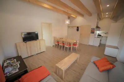 a living room with a couch and a table at Apartments Pikon in Bohinj