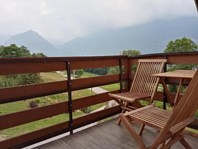 a pair of chairs and a table on a balcony at Apartment Vida in Bovec