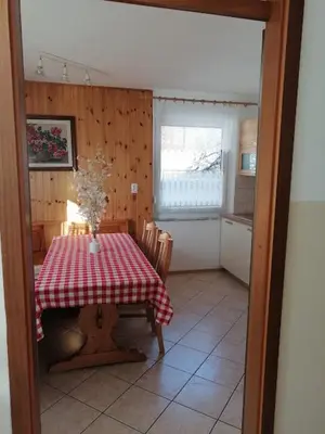 a kitchen with a table with a red and white checkered table cloth at Apartment Vida in Bovec