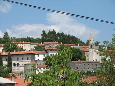 a view of a city with a church and buildings at Apartma Furlan in Štanjel