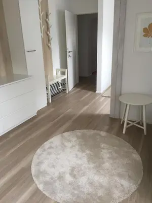 a living room with a rug and a table at Kirhouse Apartment in Bohinjska Bela