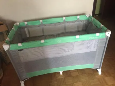 a bed with a green frame on the floor at Kirhouse Apartment in Bohinjska Bela