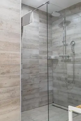 a shower with a glass door in a bathroom at Mountain view Glamping in Dovje