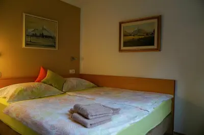 a bedroom with a bed with towels on it at Apartment Alpea in Bovec