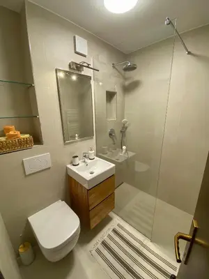 a bathroom with a toilet and a sink and a shower at Apartment Alpea in Bovec