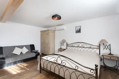 a bedroom with a bed and a couch at Holiday Lake in Bled