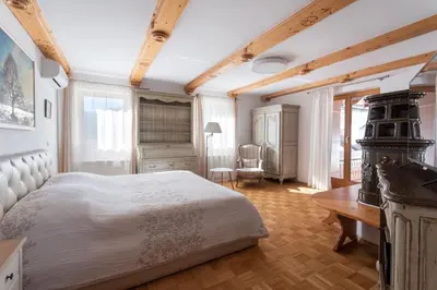 a bedroom with a white bed and a desk at Holiday Lake in Bled