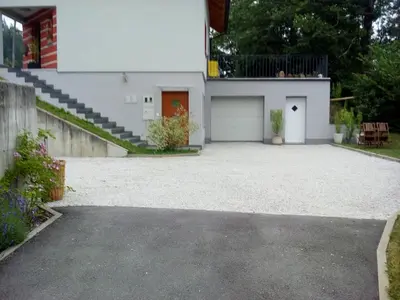 a driveway in front of a house with a garage at Apartment Visak in Bled