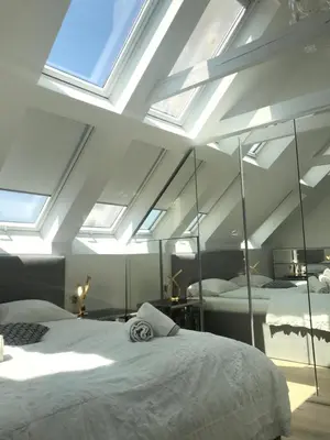 a bedroom with two beds and a skylight at AB Ljubljana - The Princess Castle Triplex in Ljubljana