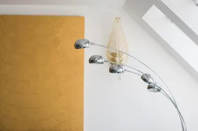 a metal chandelier hanging from a wall next to a window at AB Ljubljana - The Princess Castle Triplex in Ljubljana