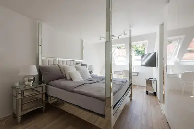 a bedroom with a canopy bed with a mirror at AB Ljubljana - The Princess Castle Triplex in Ljubljana