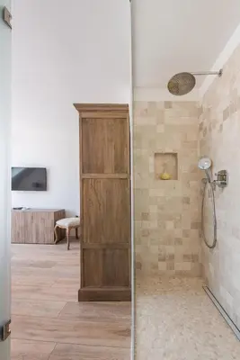 a shower with a wooden door in a bathroom at AB Ljubljana - The Princess Castle Triplex in Ljubljana