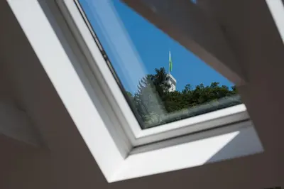 a window with a view of a house at AB Ljubljana - The Princess Castle Triplex in Ljubljana