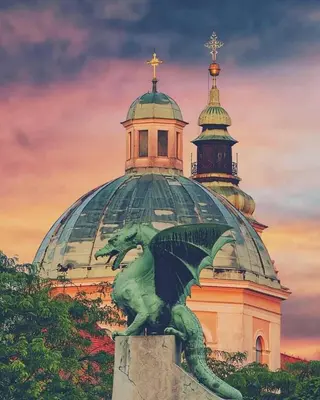a green lizard statue in front of a building at AB Ljubljana - The Princess Castle Triplex in Ljubljana