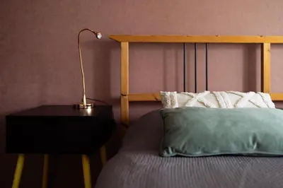 a bedroom with a bed with a lamp on a night stand at Large Two Bedroom Family APP - free parking in Ljubljana