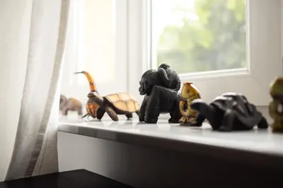 a group of figurines sitting on a window sill at Large Two Bedroom Family APP - free parking in Ljubljana