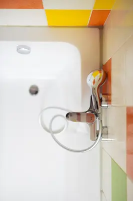 a bathroom with a sink and a faucet at Large Two Bedroom Family APP - free parking in Ljubljana