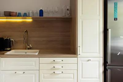 a kitchen with white cabinets and a sink and a refrigerator at Large Two Bedroom Family APP - free parking in Ljubljana
