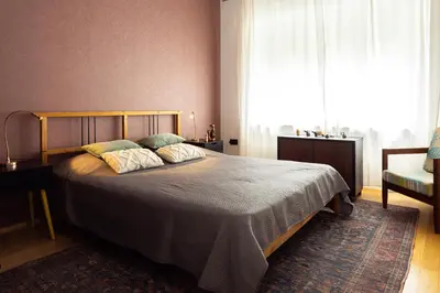 a bedroom with a bed and a large window at Large Two Bedroom Family APP - free parking in Ljubljana