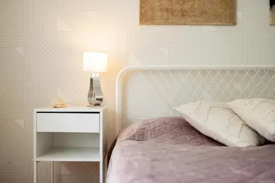 a bedroom with a bed and a table with a lamp at Large Two Bedroom Family APP - free parking in Ljubljana