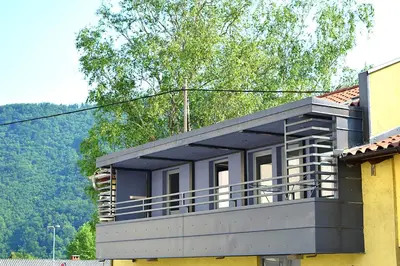 a house with a balcony on top of it at Hiša 2 in Tolmin
