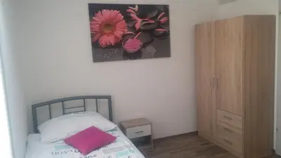 a bedroom with a bed and a picture on the wall at Hiša 2 in Tolmin