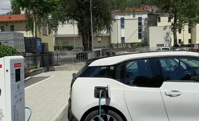 a white car parked next to a parking meter at Hiša 2 in Tolmin