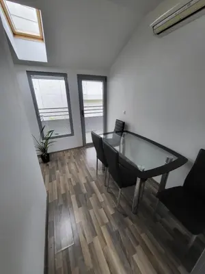a office with a glass desk and a chair at Hiša 2 in Tolmin