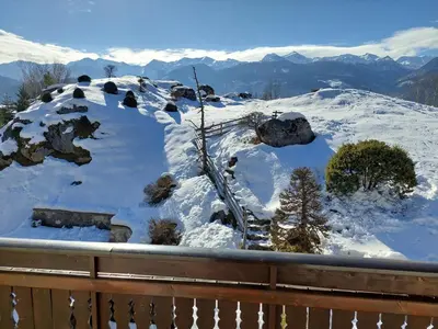 a snow covered mountain with mountains in the background at Apartmaji Vesna in Bohinj