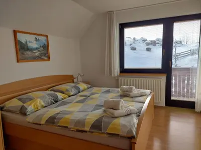 a bedroom with a bed with two pillows on it at Apartmaji Vesna in Bohinj