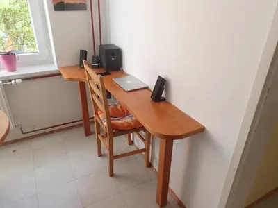a wooden desk with a laptop and speakers on it at Cozy little nest, Bled region in Jesenice